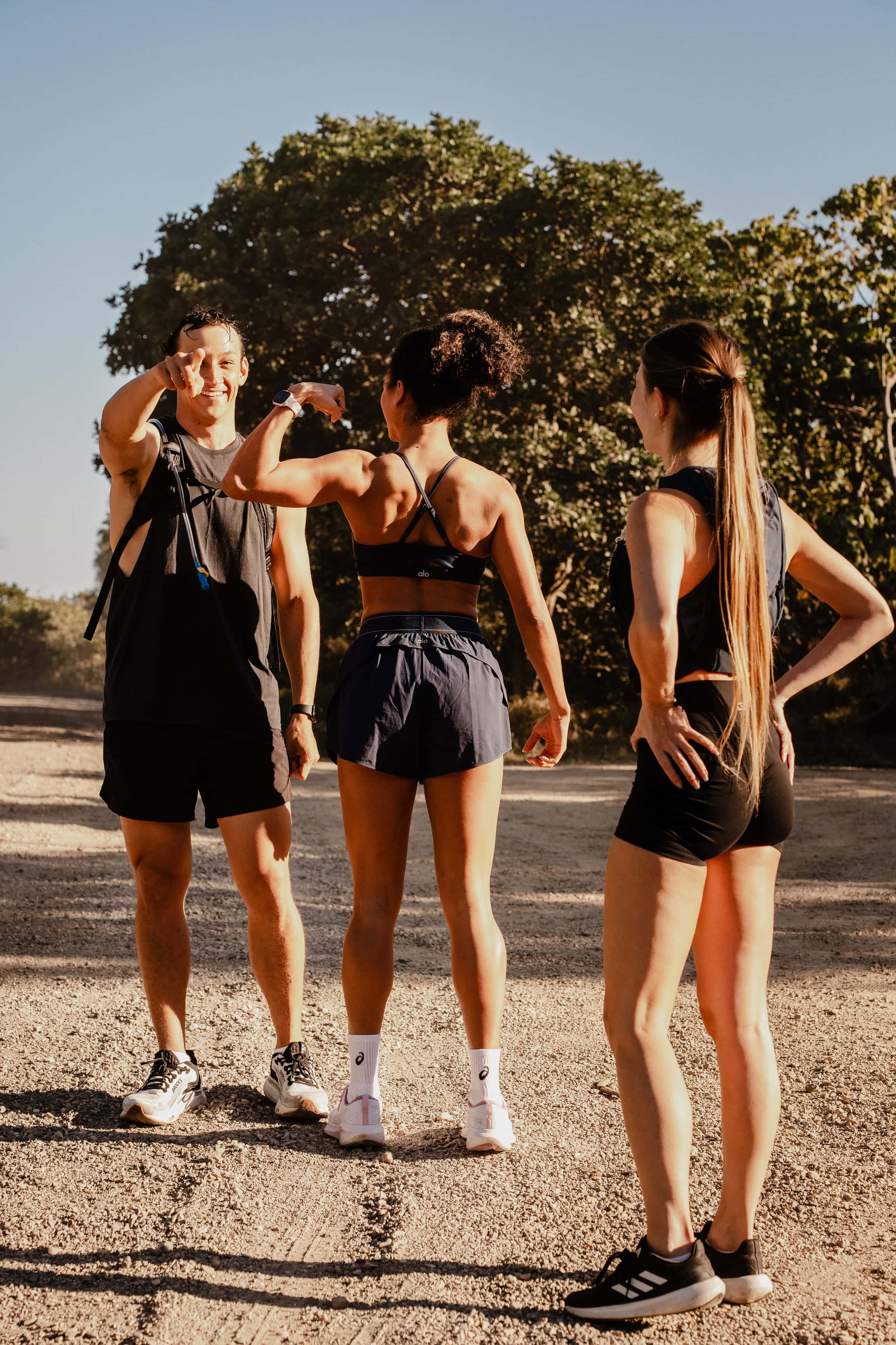 Three trail runners sharing a laugh together after a run